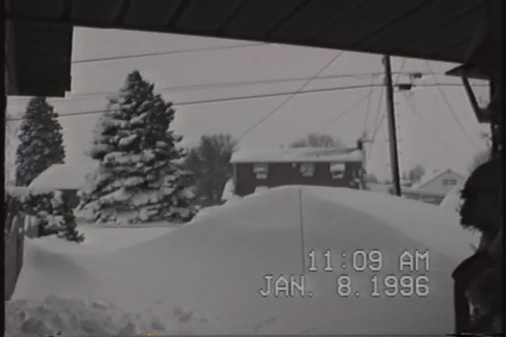 Since a winter storm is affecting a good portion of the US, here’s a still from a home VHS recording of the Blizzard of ‘96. (Source: Wikipedia)